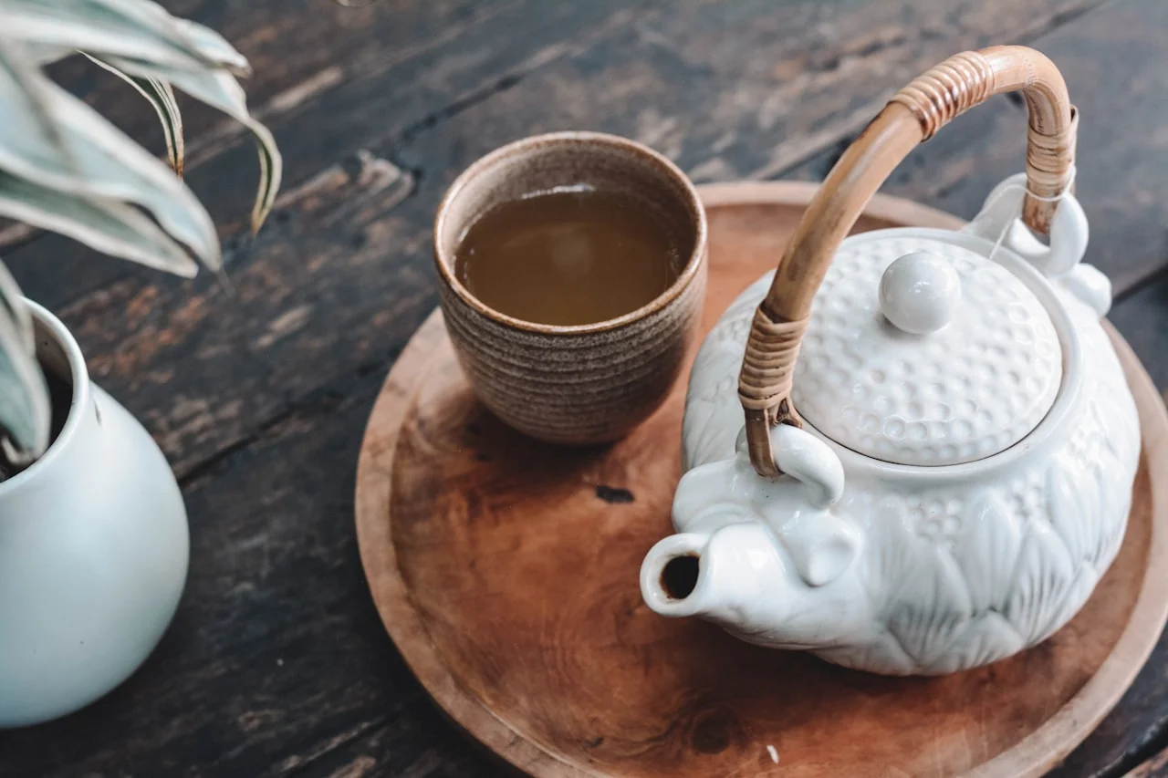 Elderly Japanese tea farmer hand-picking tea leaves - aging workforce crisis in Japan tea industry