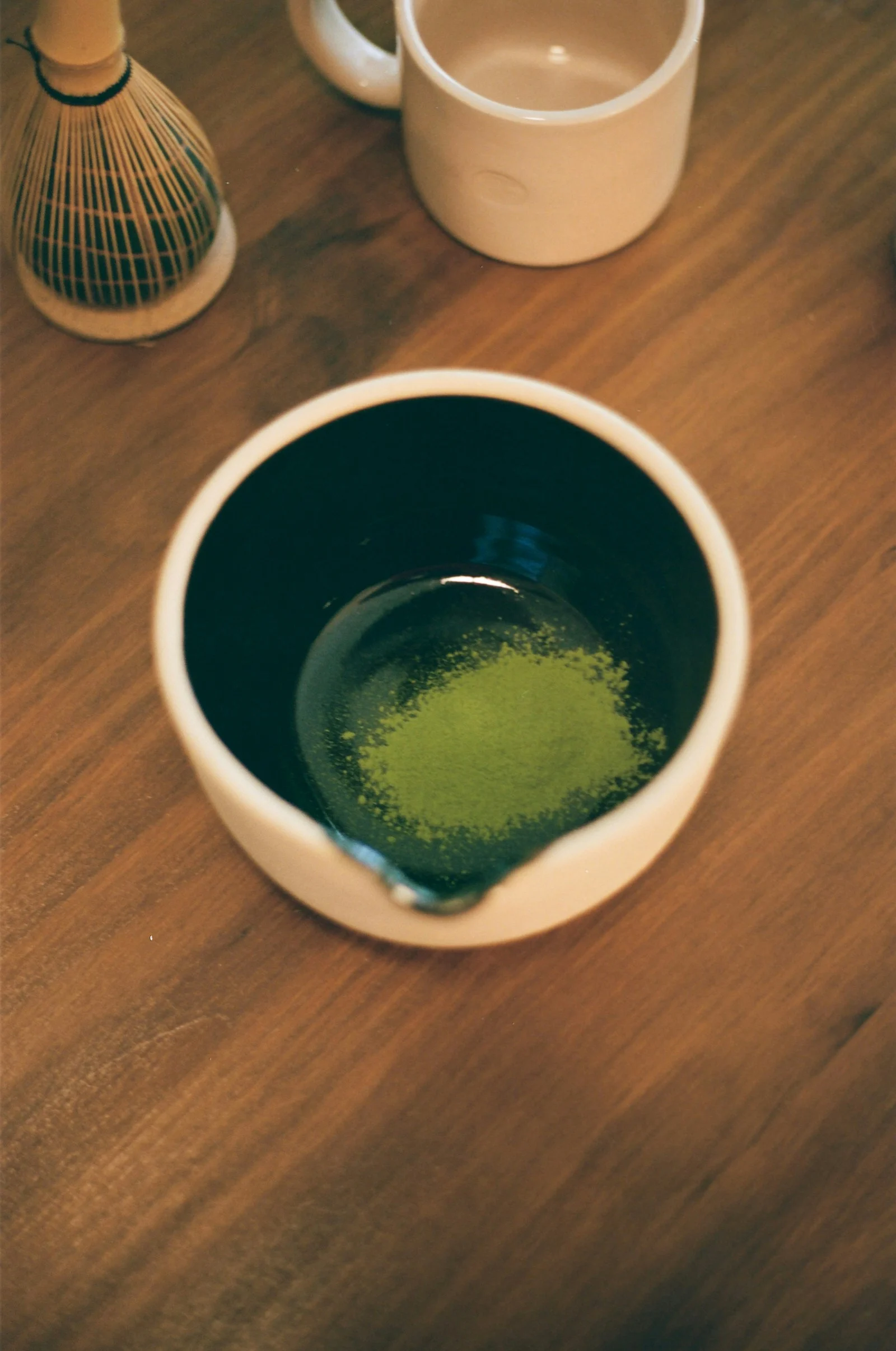 Ceremonial grade matcha powder in a traditional bowl, vibrant green color indicating proper shading and high chlorophyll content